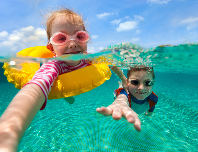 Kids playing in a pool, parents at ease